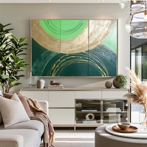 a modern living room with a large abstract painting on the wall, a white sofa, a glass-fronted entertainment unit, and various decorative elements such as plants and vases.