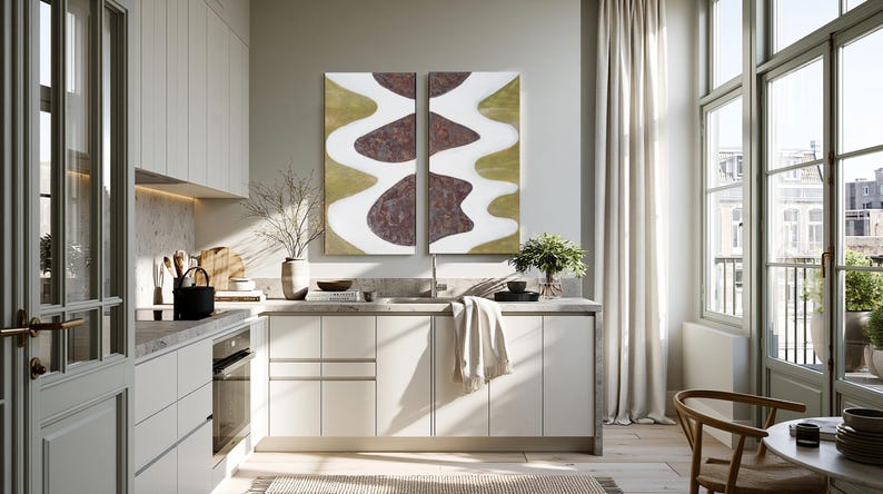 a modern, well-lit kitchen with white cabinets, a large abstract painting on the wall, and a dining table with chairs.