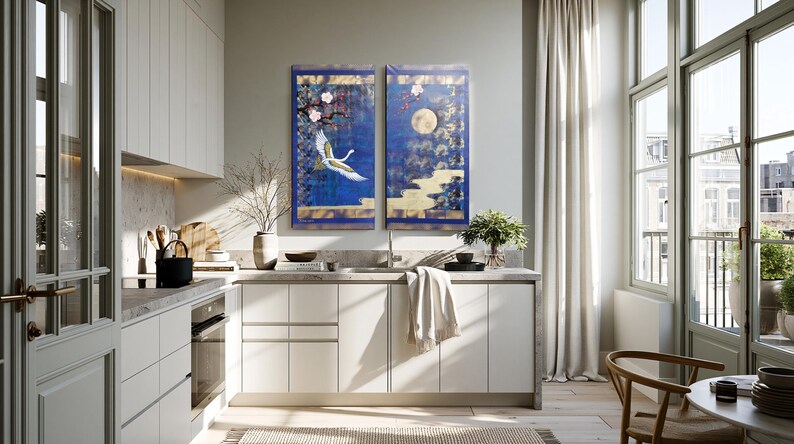 a modern, well-lit kitchen with white cabinets, a large window, and a blue and white wall art piece.
