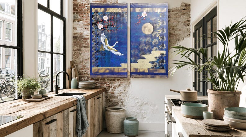 a cozy kitchen with a large window overlooking a city street, featuring a wooden countertop, a sink, and various decorative elements such as potted plants and a large painting on the wall.