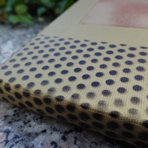 a close-up view of a surface with a pattern of black and white polka dots.