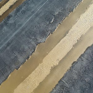 a close-up view of a textured surface with a striped pattern, combining shades of blue and gold.