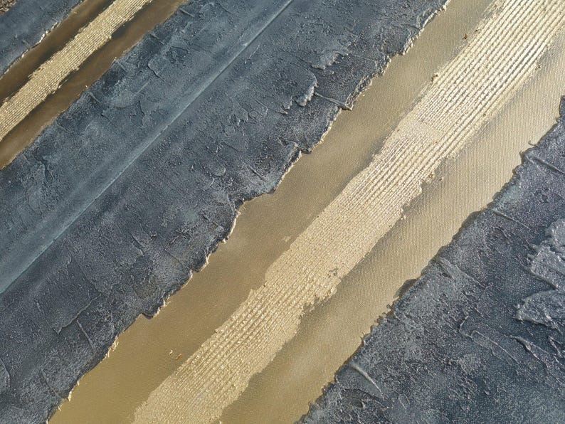 a close-up view of a textured surface with a striped pattern, combining shades of blue and gold.