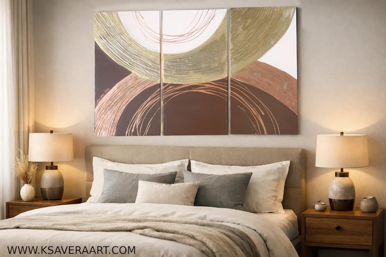 a modern bedroom with a large abstract painting on the wall above a bed with white pillows and a gray throw blanket.
