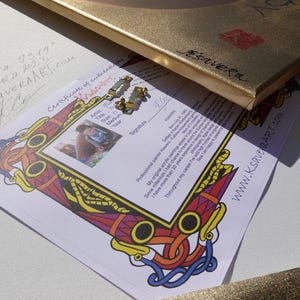 a certificate of authenticity for a painting, with a colorful frame and a website address.