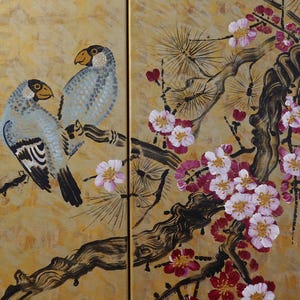 The image is a painting of two birds perched on a branch with pink and white flowers. The painting is set against a golden background, creating a warm and vibrant atmosphere.