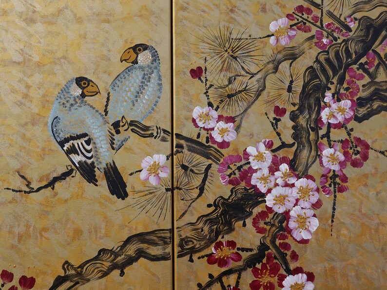 The image is a painting of two birds perched on a branch with pink and white flowers. The painting is set against a golden background, creating a warm and vibrant atmosphere.