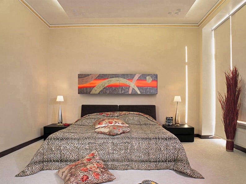 a modern bedroom with a large bed, a nightstand, and a painting on the wall. The room has a neutral color scheme with beige walls and a black and white patterned bedspread.
