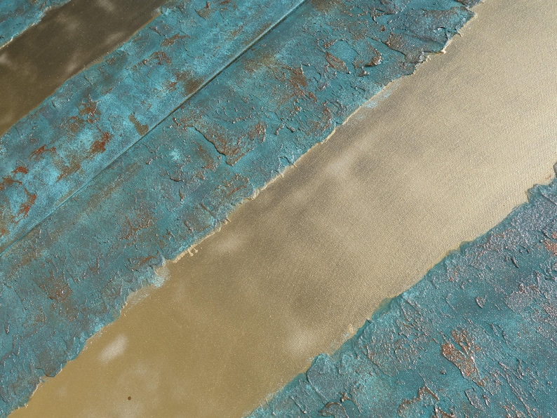a close-up view of a textured surface with a combination of blue and gold colors. The surface appears to be a mix of paint or material with a textured, weathered appearance.