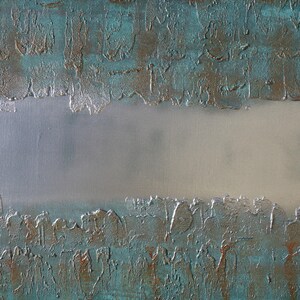 The image is a close-up of a textured surface with a metallic sheen, featuring a metallic sheen and a white background.