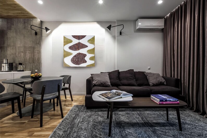 a modern living room with a black sofa, a wooden coffee table, and a dining table with chairs. The room has a minimalist and contemporary design, with a large abstract painting on the wall and a window with curtains.
