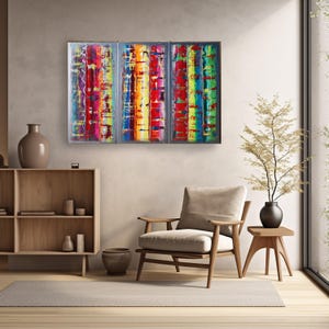 a modern living room with a large, colorful abstract painting hanging on the wall above a wooden chair. The room has a minimalist and clean design, with a wooden floor and a small table with a vase of flowers.