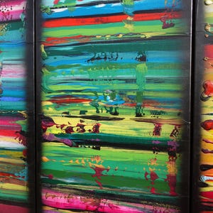 The image is a vibrant, abstract painting with bold, colorful brushstrokes and a sense of movement and energy.