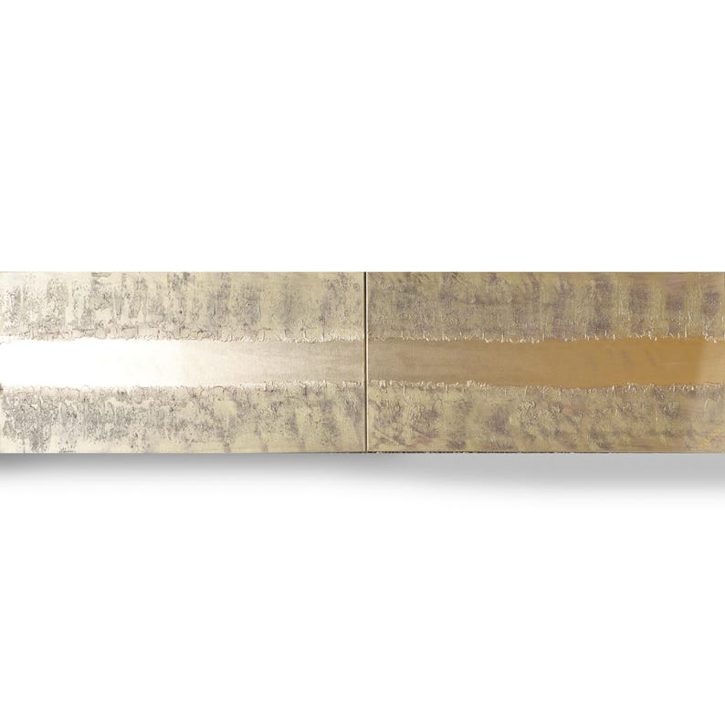 a close-up view of a metallic surface with a textured, metallic appearance. The surface appears to be made of a shiny, metallic material, possibly brass or bronze, and has a textured pattern. The image does not contain any discernible objects or actions, and there are no specific actions or movements depicted. The image does not contain any text or other objects, and it does not depict any actions or movements.