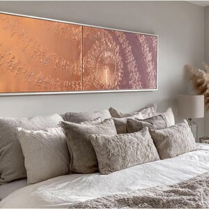 a well-decorated bedroom with a large bed, a framed artwork on the wall, and a large window overlooking a scenic outdoor view.