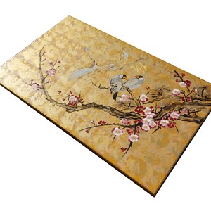 The image is a painting of two birds perched on a branch with flowers.