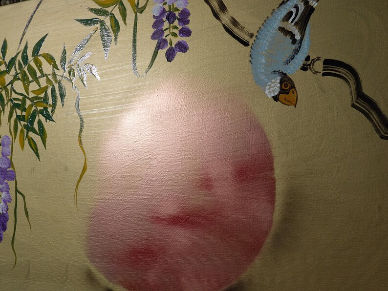 The image is a painting featuring a blue bird perched on a branch with purple flowers. The painting is set against a beige background with a large pink circle in the center.