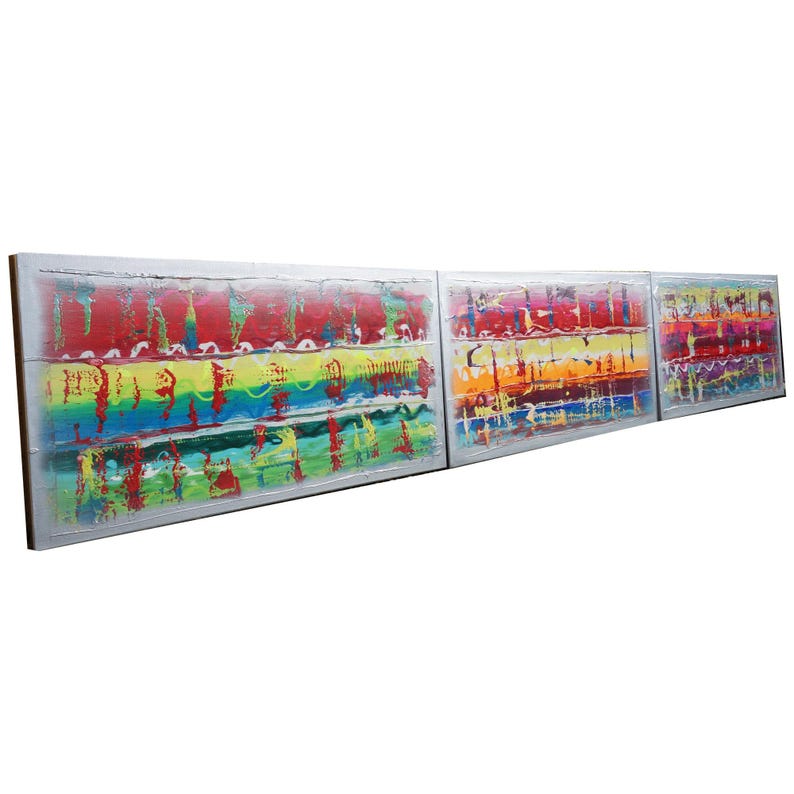 three large, colorful paintings displayed side by side.