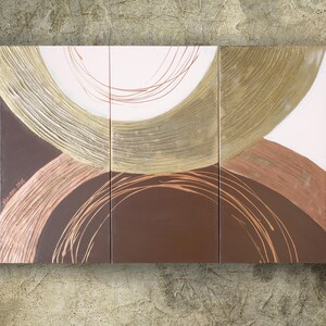 The image is a triptych of abstract art pieces, featuring a large circular design with a mix of brown, gold, and white colors.