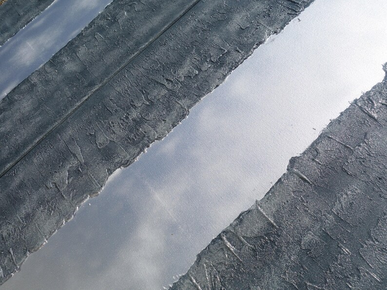 a close-up view of a textured surface with a metallic sheen, featuring a diagonal line running through it.