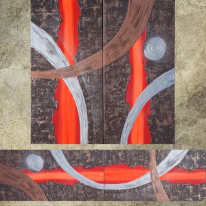 The image is a large abstract painting with bold, vibrant colors and dynamic shapes. The painting features a mix of red, orange, and brown tones, along with metallic silver and brown accents. The composition is dynamic, with curved lines and shapes that create a sense of movement and energy. The painting is a striking visual representation of abstract art, capturing the viewer's attention and inviting them to explore the various elements and colors.
