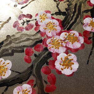 a close-up view of a painting of pink and white flowers with gold centers, set against a dark background with black lines and shapes.