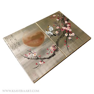 The image is a two-panel artwork featuring a large moon and cherry blossom branches with pink flowers. The moon is depicted in the top left panel, while the cherry blossoms are shown in the top right panel. The artwork is set against a white background, highlighting the colors and details of the floral designs.