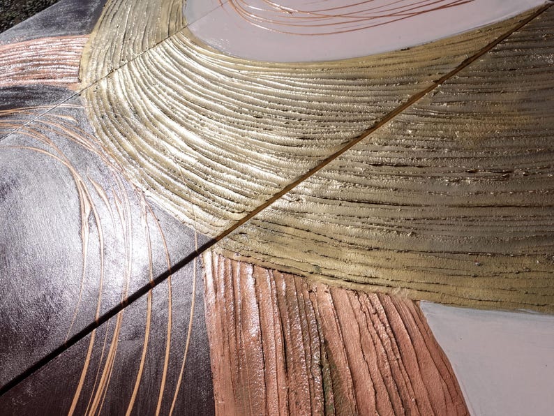 The image is a close-up of a textured surface with a metallic, textured appearance. The surface has a combination of brown, white, and gray colors, with a metallic sheen that gives it a unique and visually interesting look.