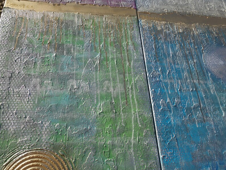 The image is a close-up of a textured surface with a variety of colors and patterns, including green, blue, and metallic elements.