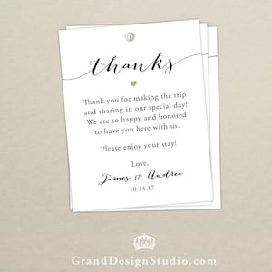 May include: White thank you card with black text that reads "thanks". The text "Thank you for making the trip and sharing in our special day! We are so happy and honored to have you here with us. Please enjoy your stay! Love, James & Andrea. 10.14.17" is printed below the word "thanks".