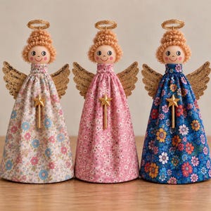 May include: Three decorative angel figurines with curly blonde yarn hair, gold wire halos, and glittery gold wings. Each figure wears a long fabric dress with a floral pattern and features a small gold star wand attached to the front of the bodice.