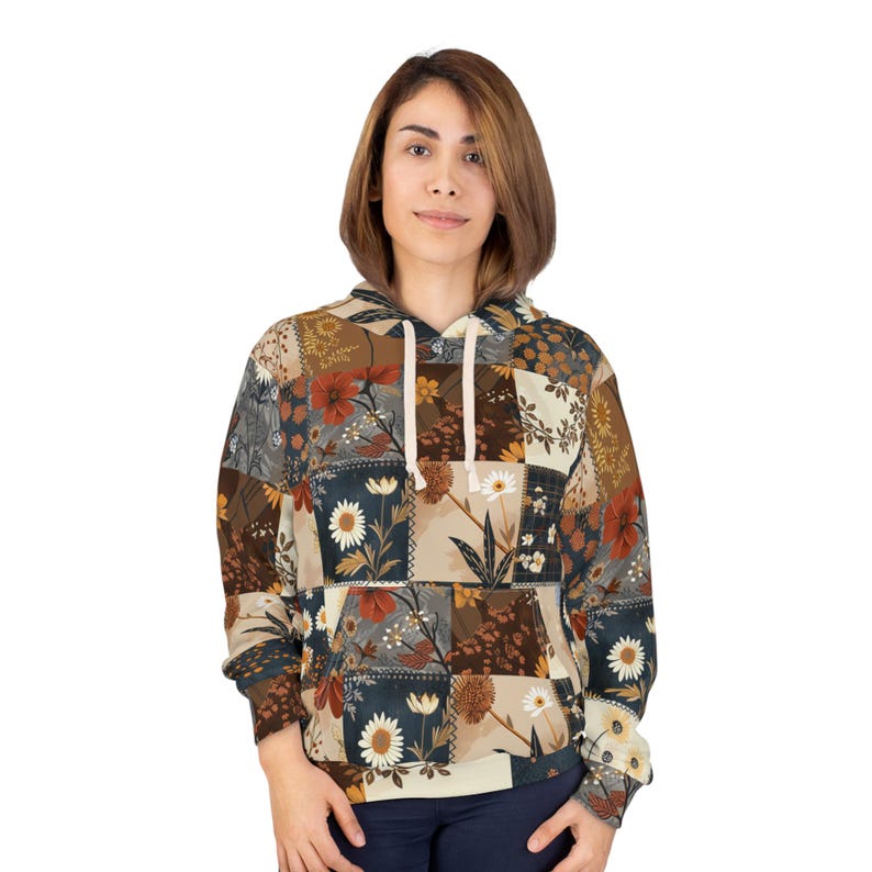 May include: A floral patchwork hoodie in shades of brown, beige, and navy blue. The hoodie features a drawstring hood and a kangaroo pocket. The design incorporates various floral patterns, creating a vintage aesthetic. The garment is made of a soft, comfortable material.
