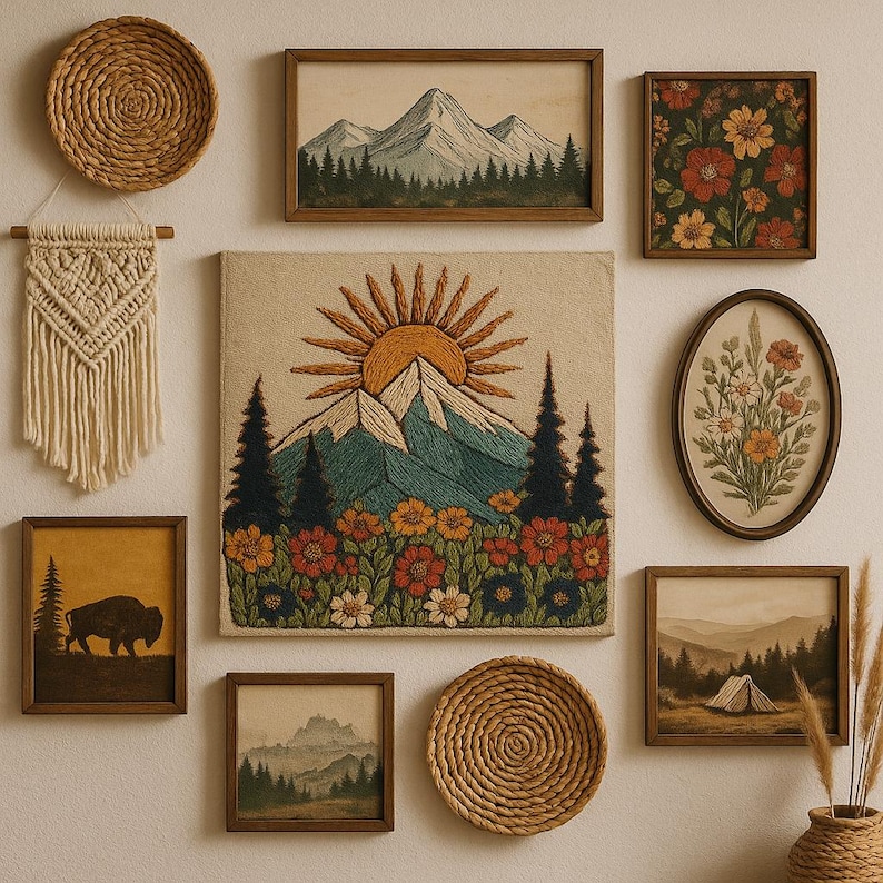 May include: A collection of framed wall art and woven decor. The art includes mountain and floral scenes in wooden frames. A large embroidered piece depicts a mountain with a sun and flowers. Woven baskets and a macrame wall hanging complete the display.