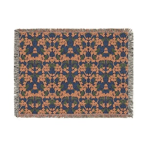 May include: A rectangular woven throw blanket featuring a repeating floral pattern with peach-colored blossoms and dark green leaves set against a deep navy blue background. The edges of the blanket are finished with a decorative fringed border.