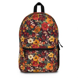 May include: A backpack with a vibrant floral pattern. The design features a burgundy background with a mix of orange, yellow, and red flowers. It has a black zipper, a black handle, and a mesh side pocket.