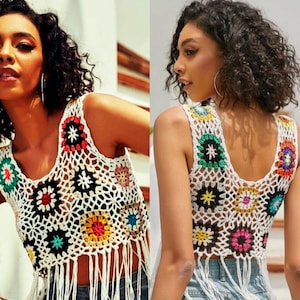 May include: White crochet top with colorful floral patterns and fringe trim. The top is sleeveless and has a scoop neck.