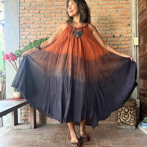 May include: A sleeveless, floor-length dress with a color gradient from orange to dark gray. The dress has a halter neckline and a flowing, circular skirt. The text "Dress D4" is visible in the upper left corner.