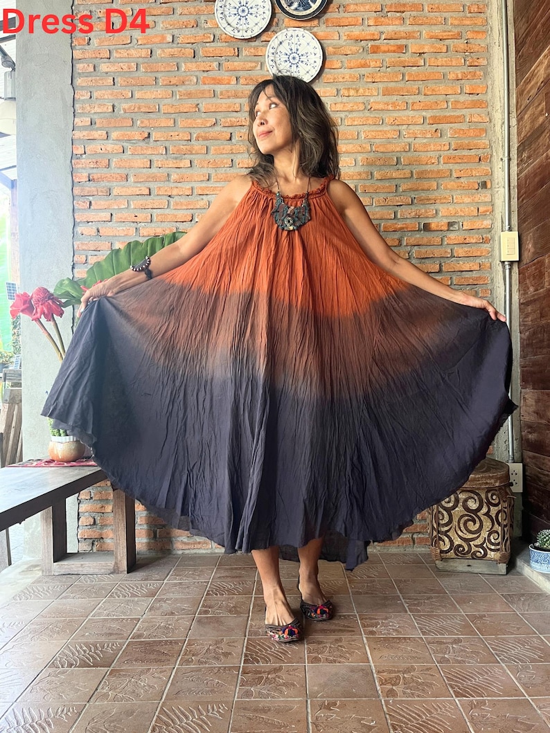 May include: A sleeveless, floor-length dress with a color gradient from orange to dark gray. The dress has a halter neckline and a flowing, circular skirt. The text "Dress D4" is visible in the upper left corner.