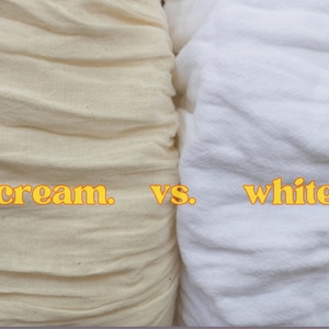 May include: Close-up of two fabric swatches, one cream and one white, with the words "cream." vs. "white" printed below them.