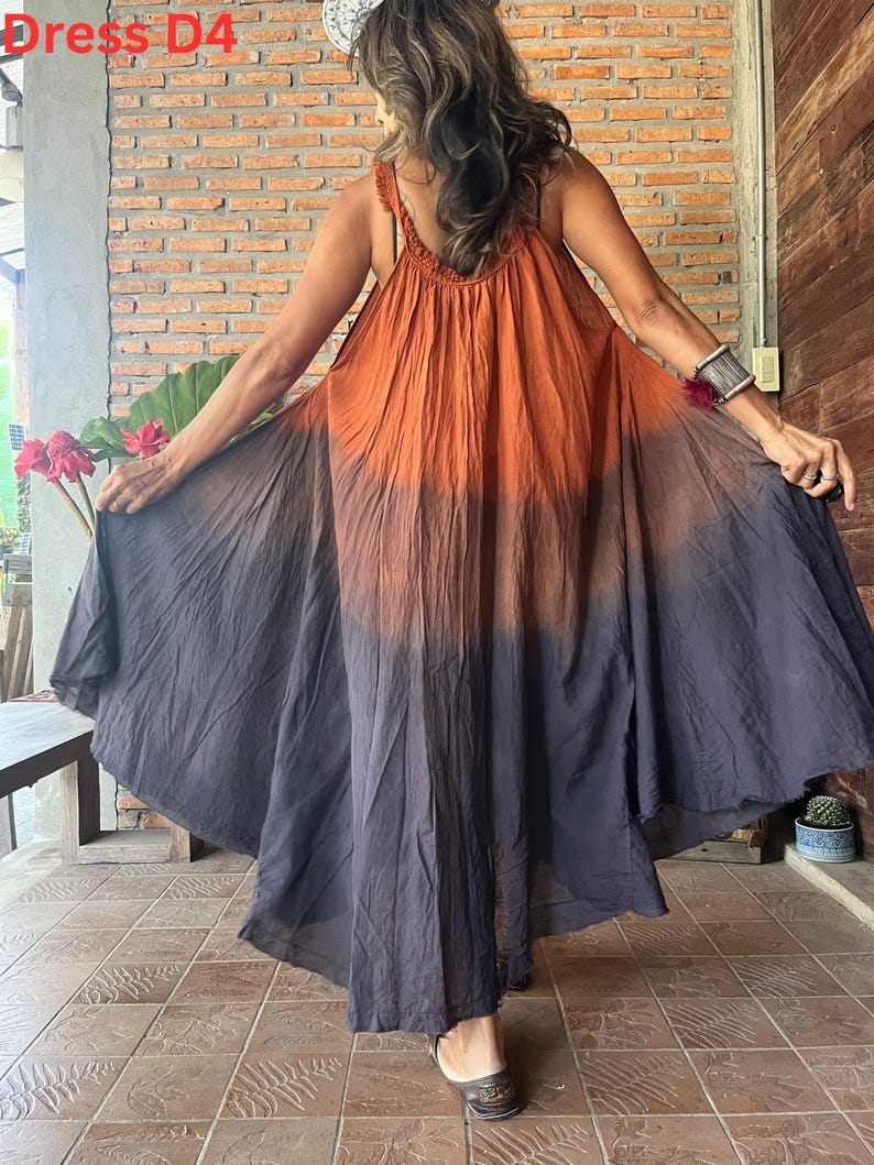 May include: A flowing, sleeveless dress with a gradient color scheme, transitioning from orange at the top to dark gray at the hem. The dress features a wide, flared skirt and a textured bodice. The text "Dress D4" is visible in the upper left corner.