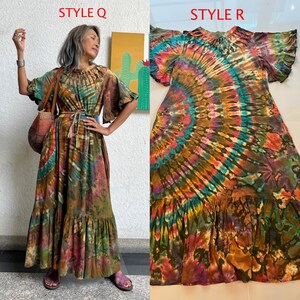 May include: Two styles of tie-dye maxi dresses with a swirling pattern of blue, green, orange, and pink. The dress on the left is longer and has a ruffled hem. The dress on the right is shorter and has a more fitted bodice. Both dresses have a tie-dye pattern.