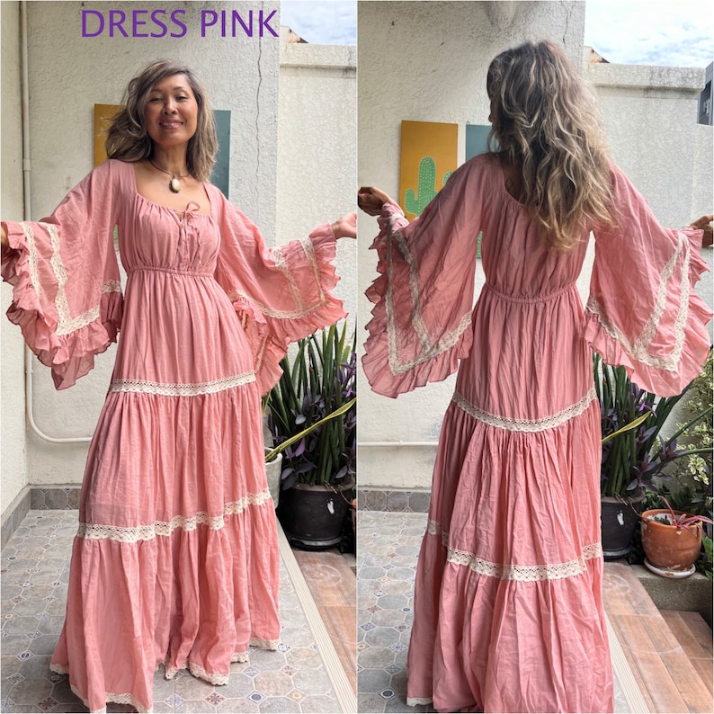 May include: A long, pink dress with a tiered skirt and bell sleeves. The dress has a lace trim and a scoop neckline.