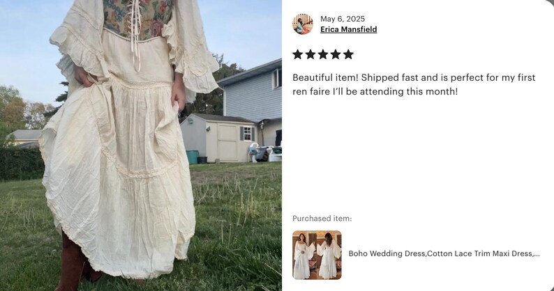 May include: A white maxi dress with a lace trim and a floral pattern on the bodice. The dress has a flowing skirt and long sleeves with ruffles. The dress is photographed outdoors in a grassy area.