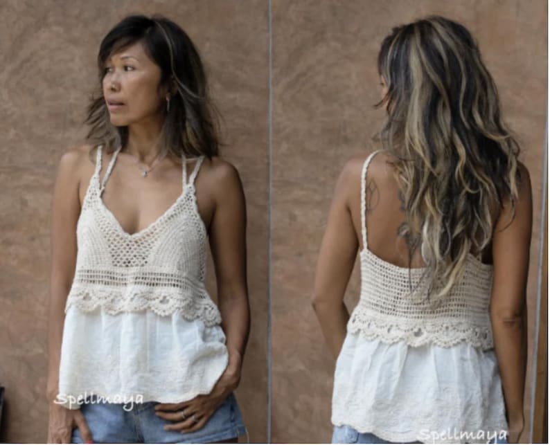 May include: A cream-coloured crochet top with a V-neck and spaghetti straps. The top has a scalloped edge and is combined with a white, embroidered bottom. The image shows the front and back of the top.