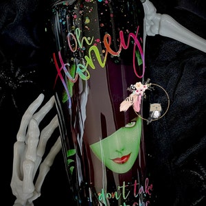 May include: A black and green tumbler with glitter and a colorful graphic of a woman with the text "Oh Honey I don't take orders".