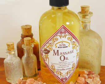 May include: A clear glass bottle with a pump dispenser filled with yellow massage oil. The bottle has a red and gold label that reads "Zir Yaby Body Brew Massage Oil" with a list of ingredients. The bottle is surrounded by pink Himalayan salt crystals on a wooden surface.