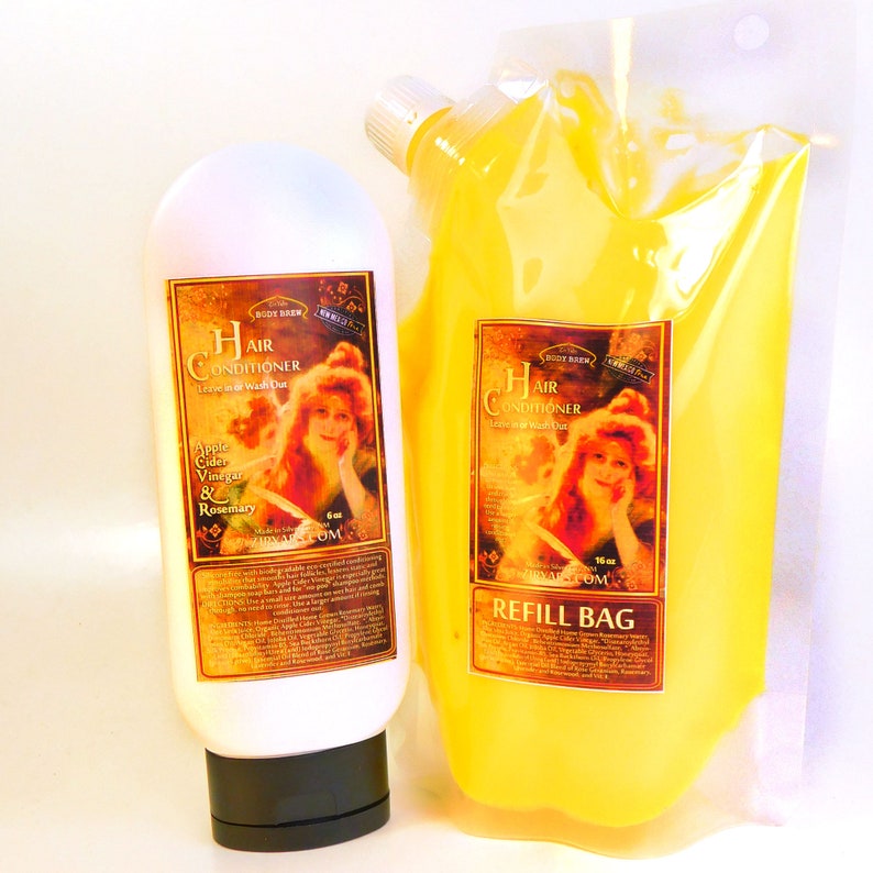 May include: Two bottles of hair conditioner, one in a clear plastic refill bag and the other in a white bottle with a black cap. Both bottles have a vintage-style label with a woman's portrait and the text "Hair Conditioner Leave in or Wash Out". The refill bag label also says "Refill Bag".