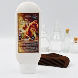 May include: A white bottle of hair conditioner with a vintage label featuring a woman with red hair. The label reads "Hair Conditioner Leave in or Wash Out Apple Cider Vinegar & Rosemary" and "SBODY BARN". The bottle is 6 oz and is made in the USA. The bottle is sitting on a white surface with a wooden comb.