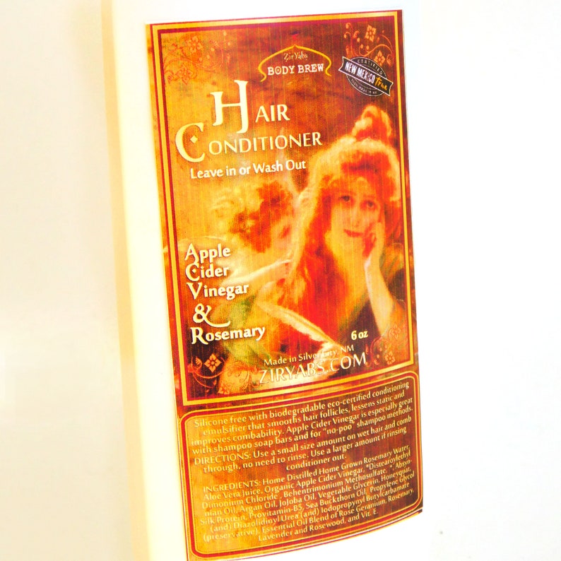 May include: A 6-ounce bottle of hair conditioner with a vintage-style label featuring a woman with red hair. The label is gold and features the text "Hair Conditioner", "Apple Cider Vinegar & Rosemary", and "Ziryabs.com".
