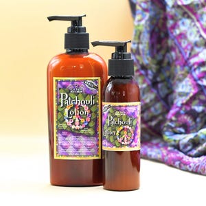 May include: Two brown bottles of Patchouli lotion with a peace sign and floral design on the label. The larger bottle is 8 fl oz and the smaller bottle is 2 fl oz.